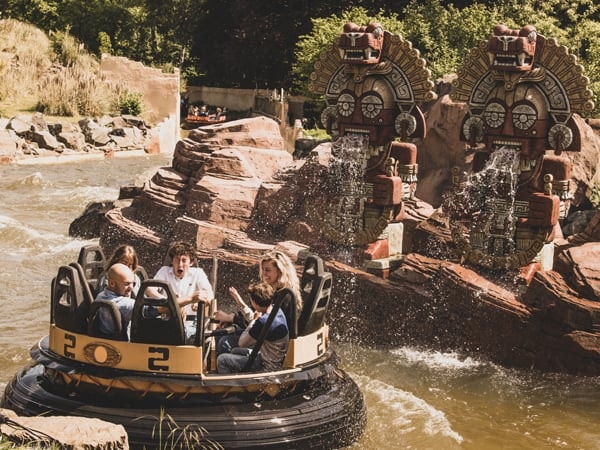 Ronde boot met een gezin in de wildwaterbaan Piraña tijdens een zonnige zomerdag in de Efteling.
