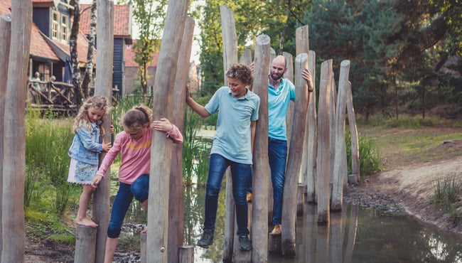 Gezin op speeltoestel in vakantiepark Efteling Bosrijk