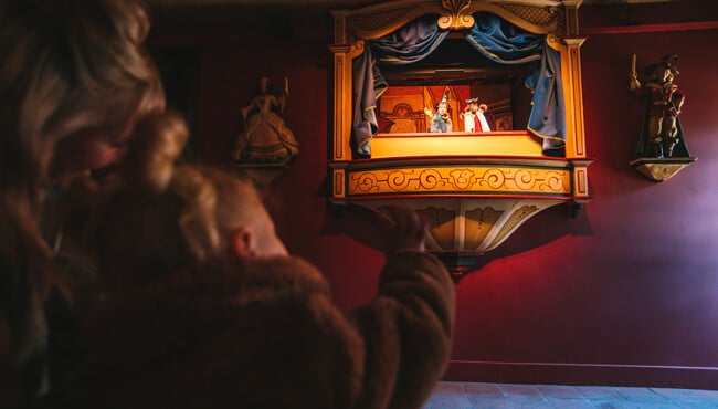 mensen kijken naar het poppenkast theater